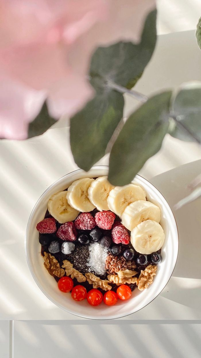 Home Overhead view of a colorful breakfast bowl with fruits and nuts. Perfect for a healthy start.